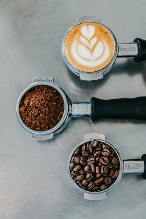 Dutch Bros keto drinks guide: coffee beans and an espresso portafilter on a table